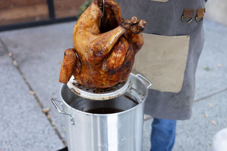 taking a fried turkey out of a boiler